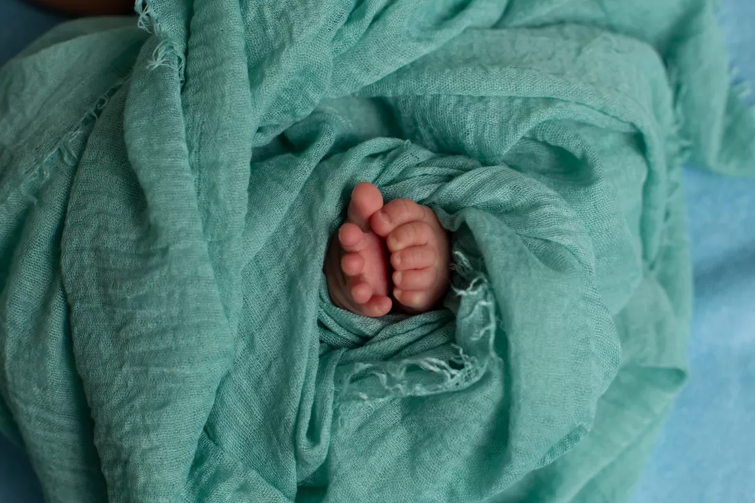baby-s-hands-are-wrapped-blanket